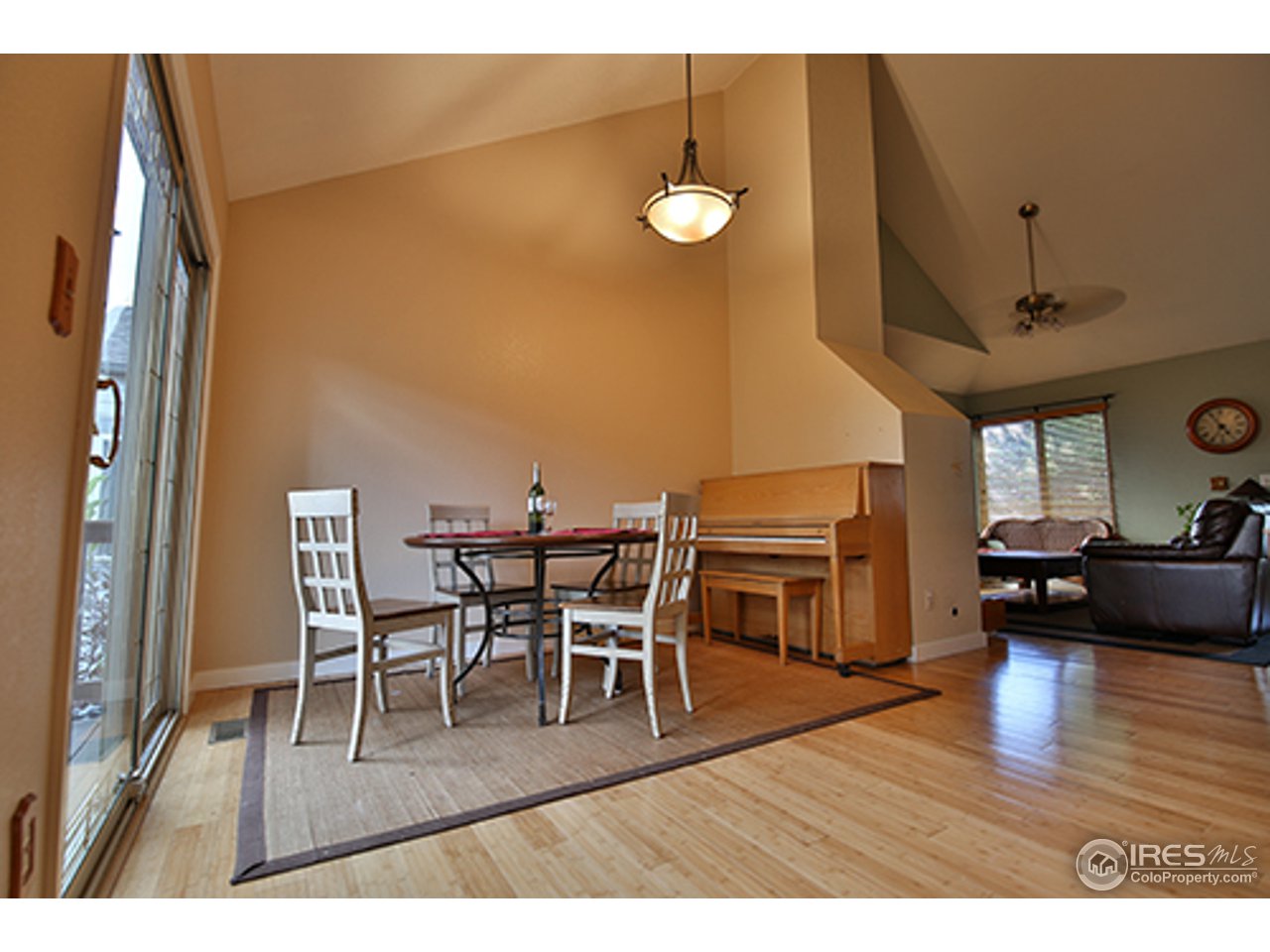 2445 Rim Drive Broomfield, CO 80020 - Photo 4 of 13 a living room with furniture a wooden floor and a fireplace
