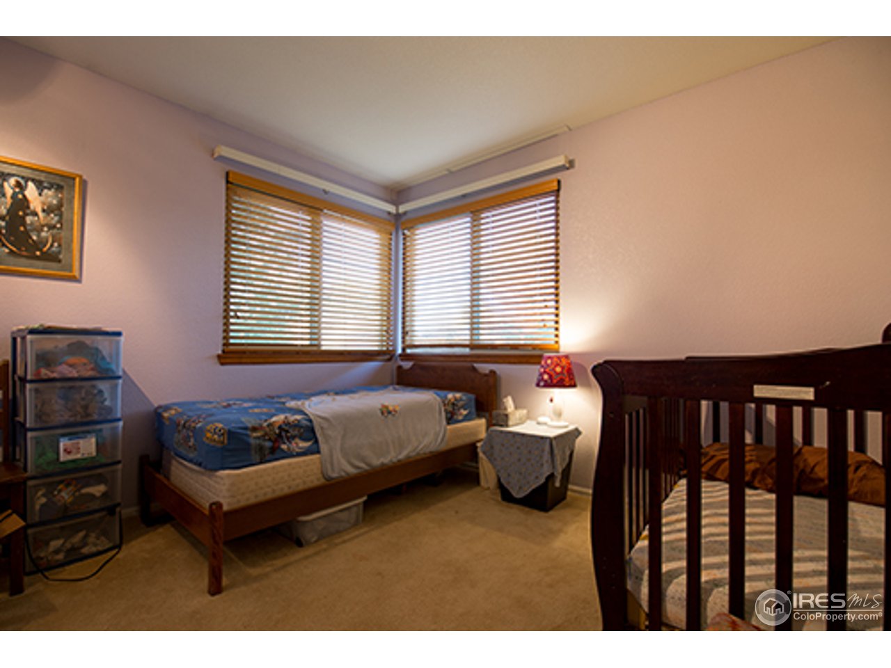 2445 Rim Drive Broomfield, CO 80020 - Photo 8 of 13 a spacious bedroom with a bed and a window