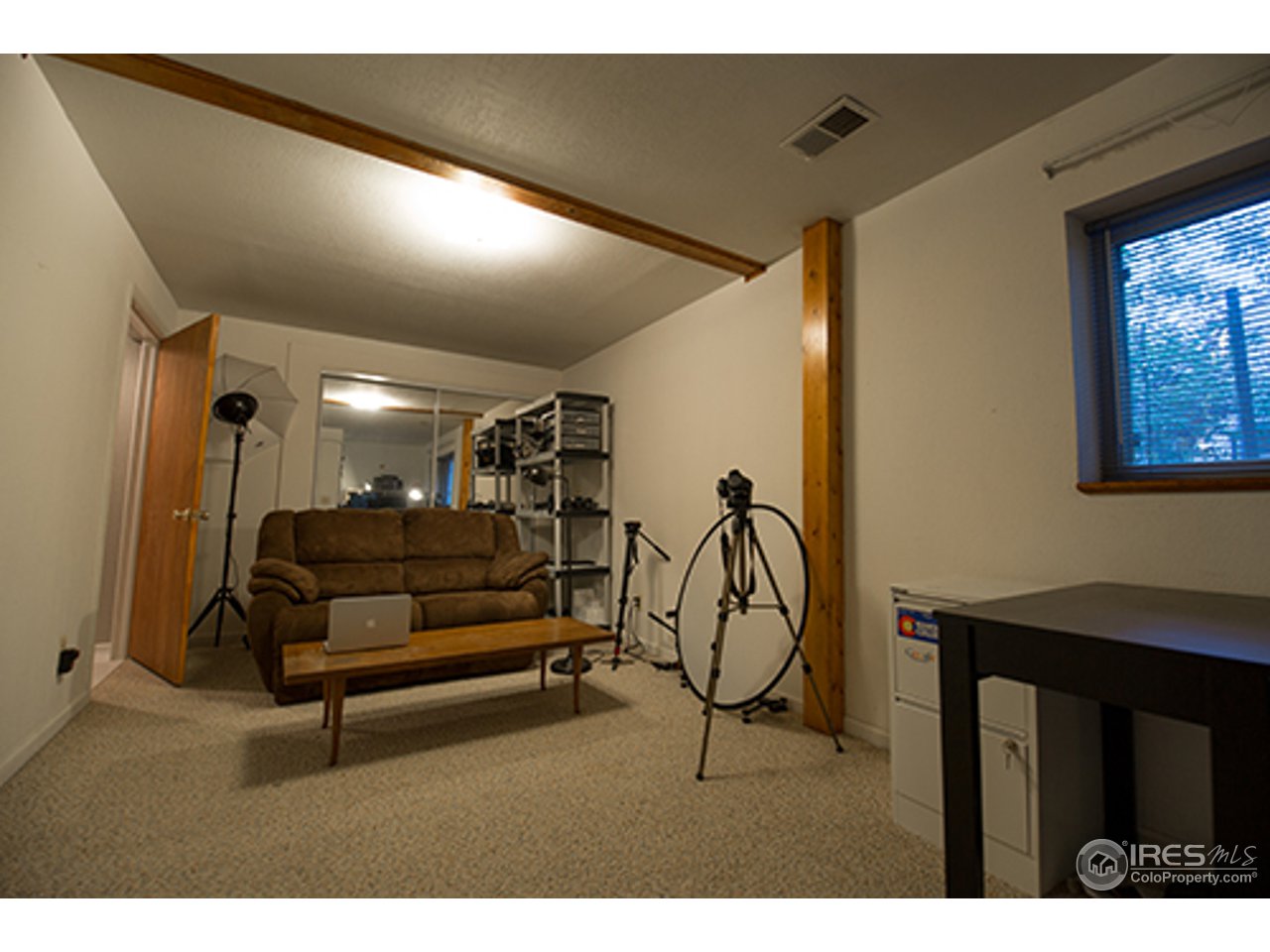 2445 Rim Drive Broomfield, CO 80020 - Photo 9 of 13 a living room with furniture a ceiling fan and a window