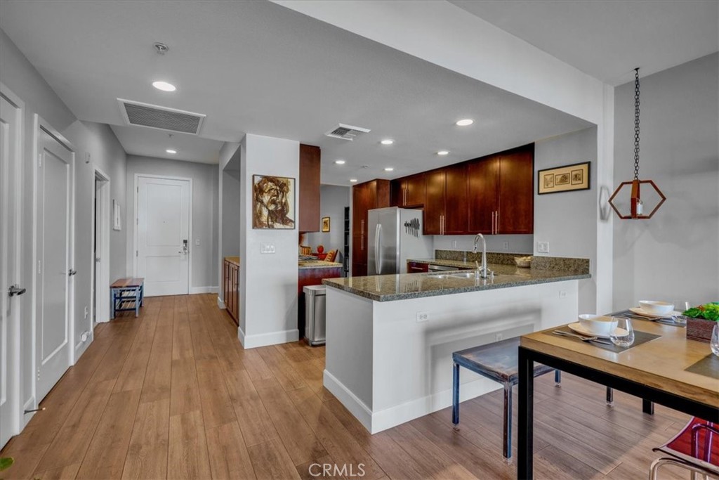 300 East 4th Street, Unit 214 Long Beach, CA 90802 - Photo 12 of 75 a kitchen with stainless steel appliances a refrigerator and microwave
