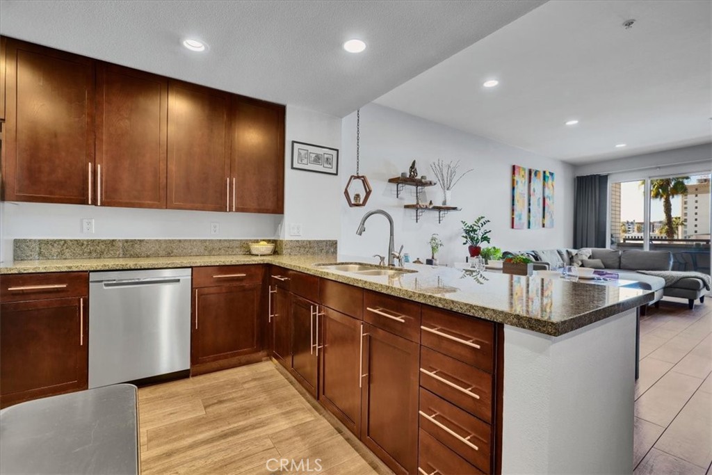 300 East 4th Street, Unit 214 Long Beach, CA 90802 - Photo 19 of 75 a kitchen with stainless steel appliances granite countertop a sink stove and cabinets