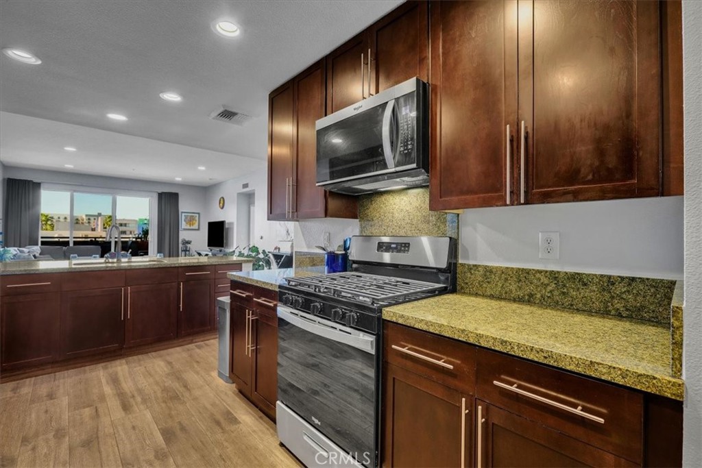 300 East 4th Street, Unit 214 Long Beach, CA 90802 - Photo 23 of 75 a kitchen with a sink and cabinets