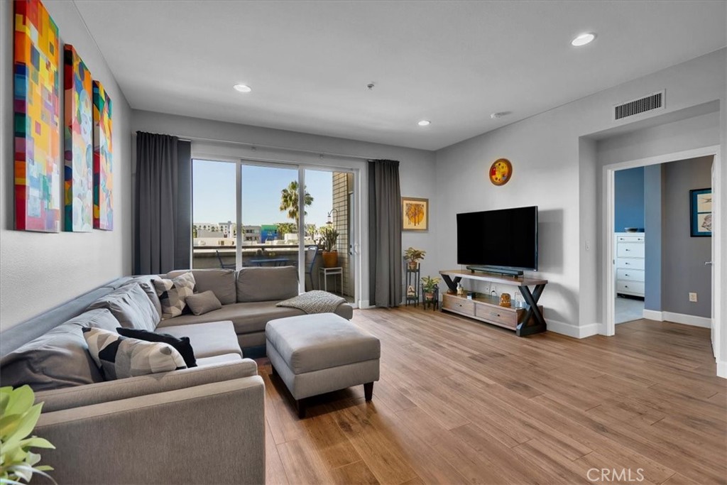 300 East 4th Street, Unit 214 Long Beach, CA 90802 - Photo 30 of 75 a living room with furniture and a flat screen tv