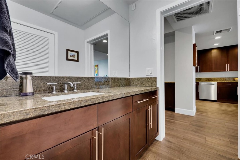 300 East 4th Street, Unit 214 Long Beach, CA 90802 - Photo 44 of 75 a kitchen with stainless steel appliances granite countertop a sink and dishwasher stove