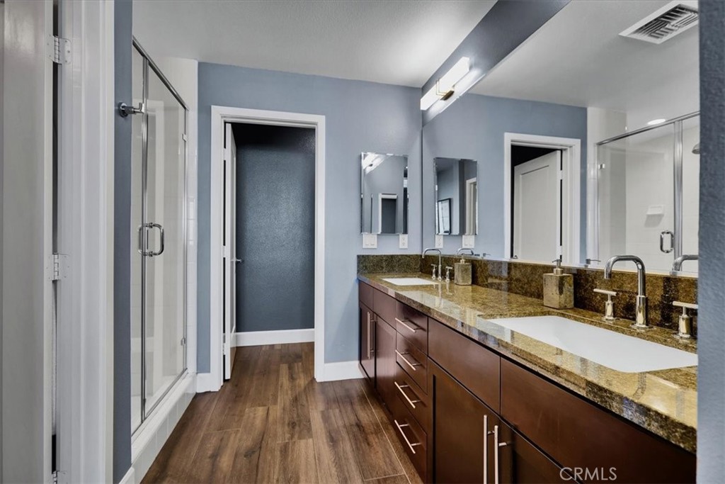 300 East 4th Street, Unit 214 Long Beach, CA 90802 - Photo 50 of 75 a bathroom with a granite countertop sink a mirror and a shower