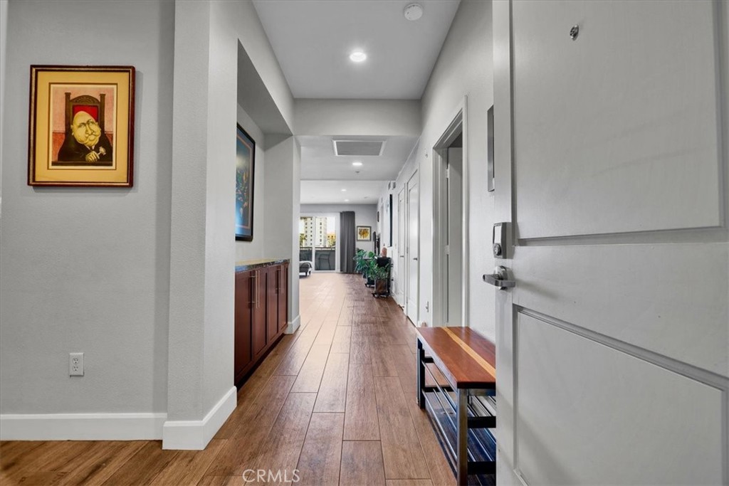 300 East 4th Street, Unit 214 Long Beach, CA 90802 - Photo 9 of 75 a view of a hallway with wooden floor and staircase