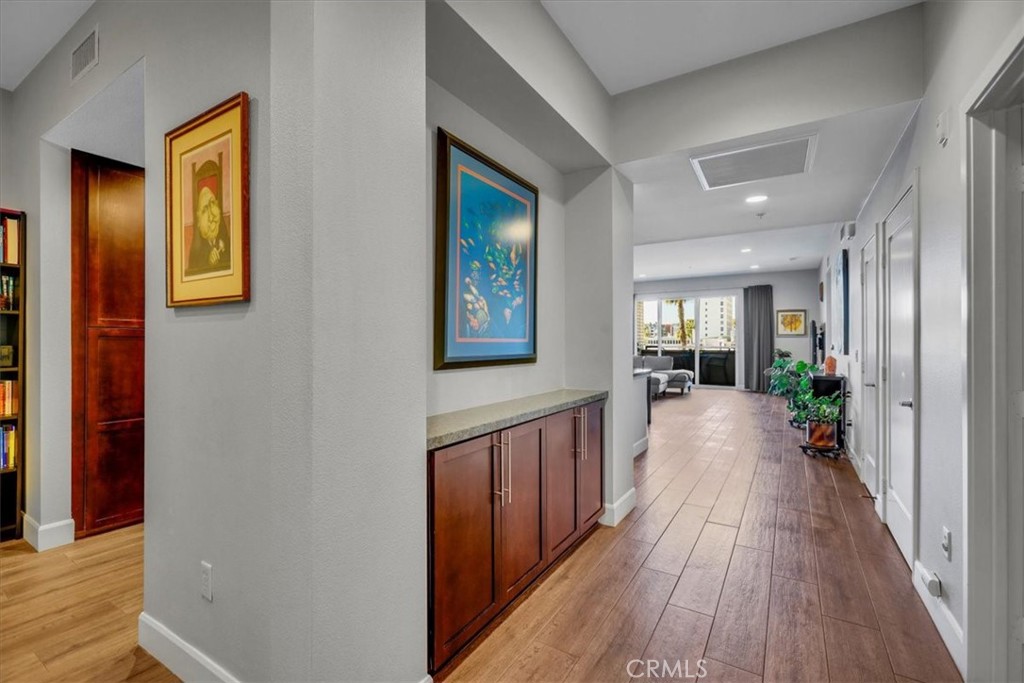 300 East 4th Street, Unit 214 Long Beach, CA 90802 - Photo 10 of 75 a view of a hallway with wooden floor and windows