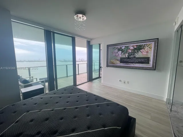 a bathroom with a tub a sink a mirror and a shower