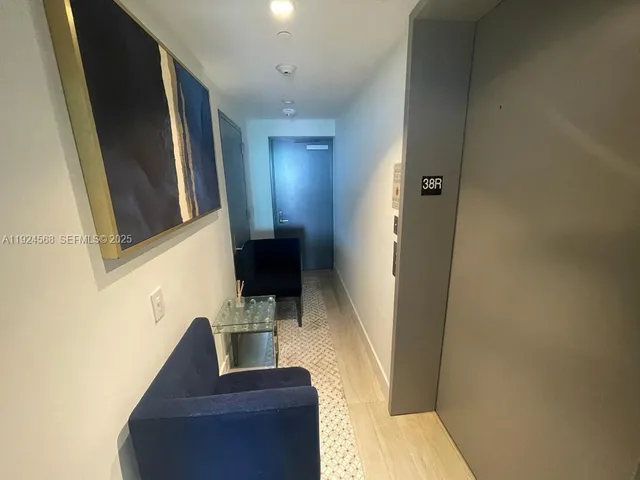 a view of a hallway with furniture and stairs