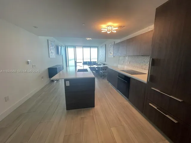a kitchen with stainless steel appliances granite countertop a sink counter space and cabinets