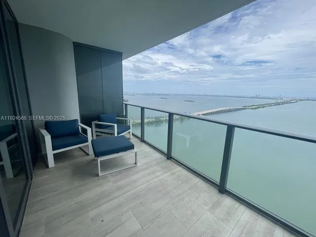 a living room with a bed and a mirror