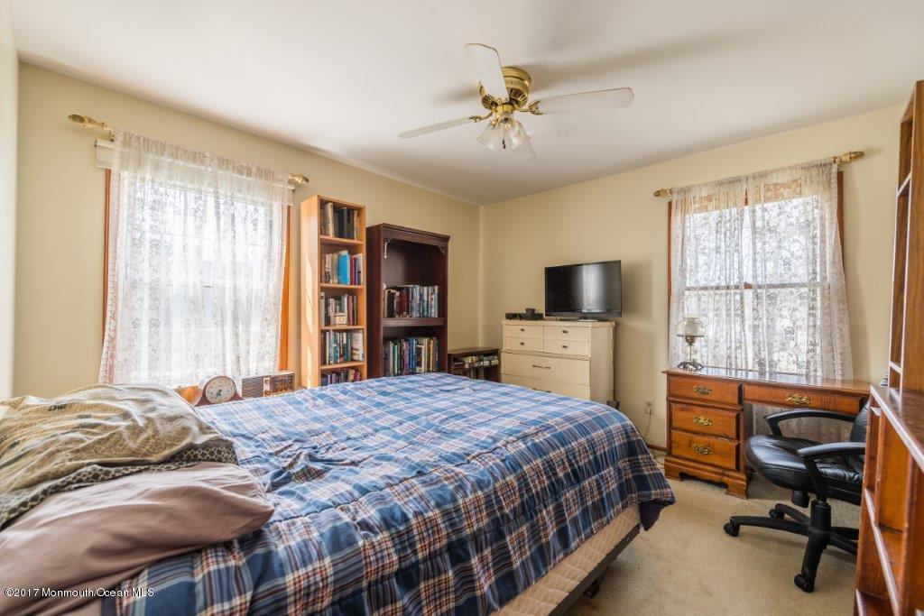 65 Chelsea Road Jackson, NJ 08527 - Photo 17 of 24 a bedroom with a bed and a flat screen tv