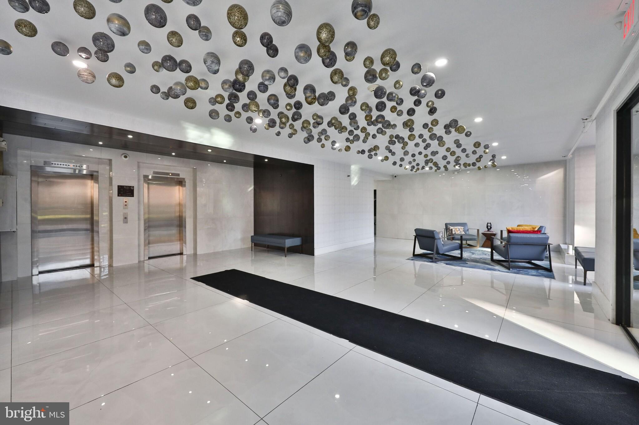 4247 Locust Street, Unit 0B108 Philadelphia, PA 19104 - Photo 13 of 38 a lobby with a chandelier and living room