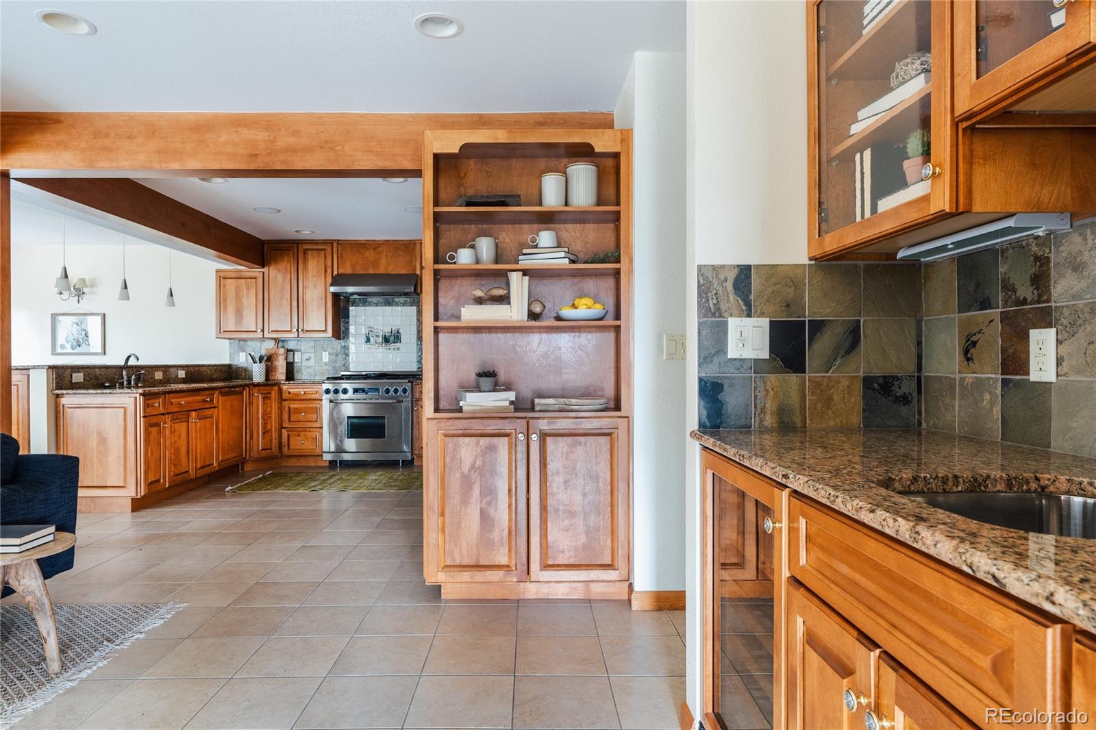 34187 Cactus Drive Evergreen, CO 80439 - Photo 11 of 39 a kitchen with stainless steel appliances granite countertop a refrigerator and a stove top oven