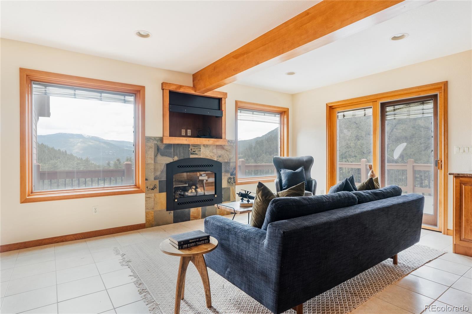 34187 Cactus Drive Evergreen, CO 80439 - Photo 14 of 39 a living room with furniture and a fireplace
