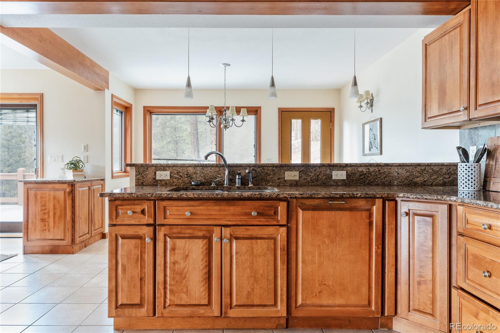 34187 Cactus Drive Evergreen, CO 80439 - Photo 18 of 39 a kitchen with granite countertop a sink and cabinets