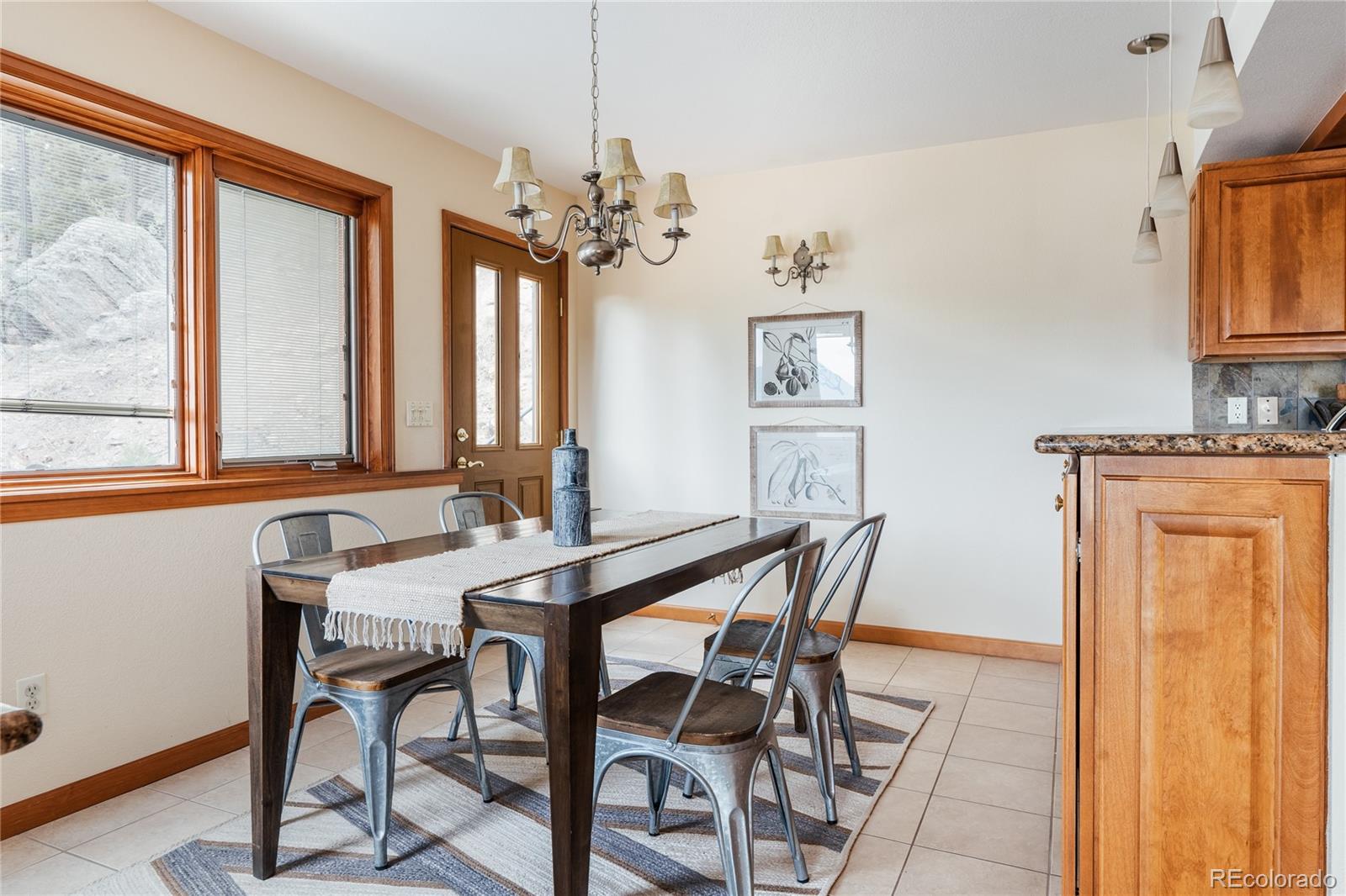 34187 Cactus Drive Evergreen, CO 80439 - Photo 19 of 39 a view of a dining room with furniture window and wooden floor