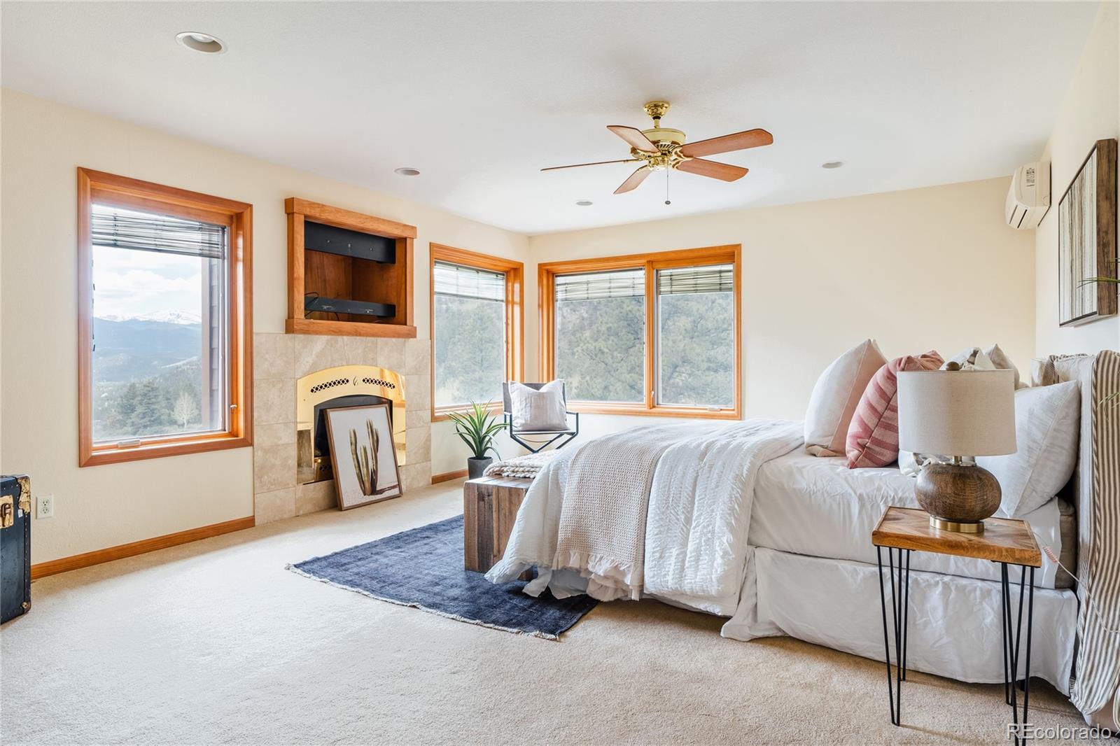 34187 Cactus Drive Evergreen, CO 80439 - Photo 26 of 39 a living room with furniture a window and a flat screen tv