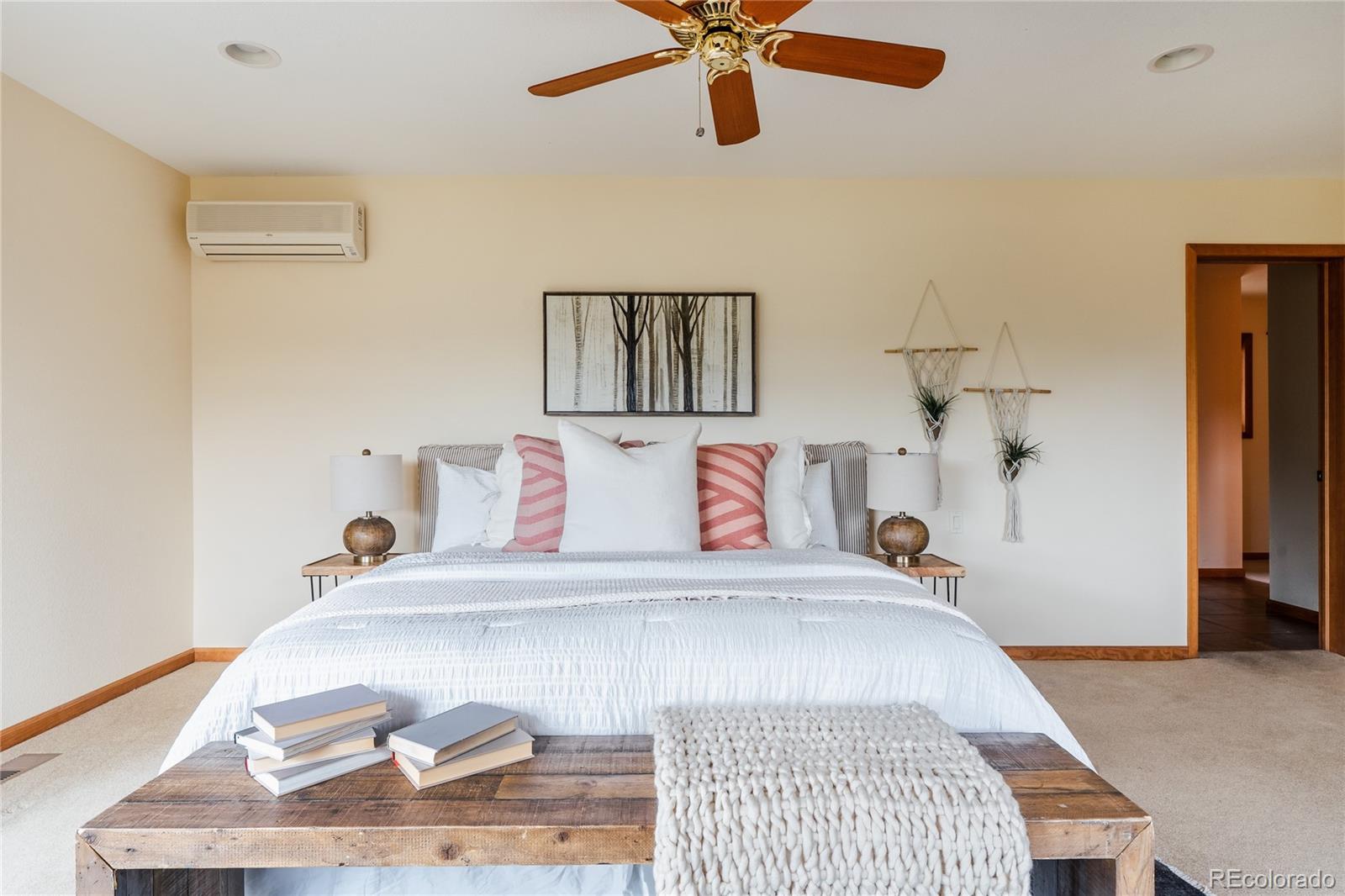 34187 Cactus Drive Evergreen, CO 80439 - Photo 27 of 39 a bedroom with a bed and wooden floor