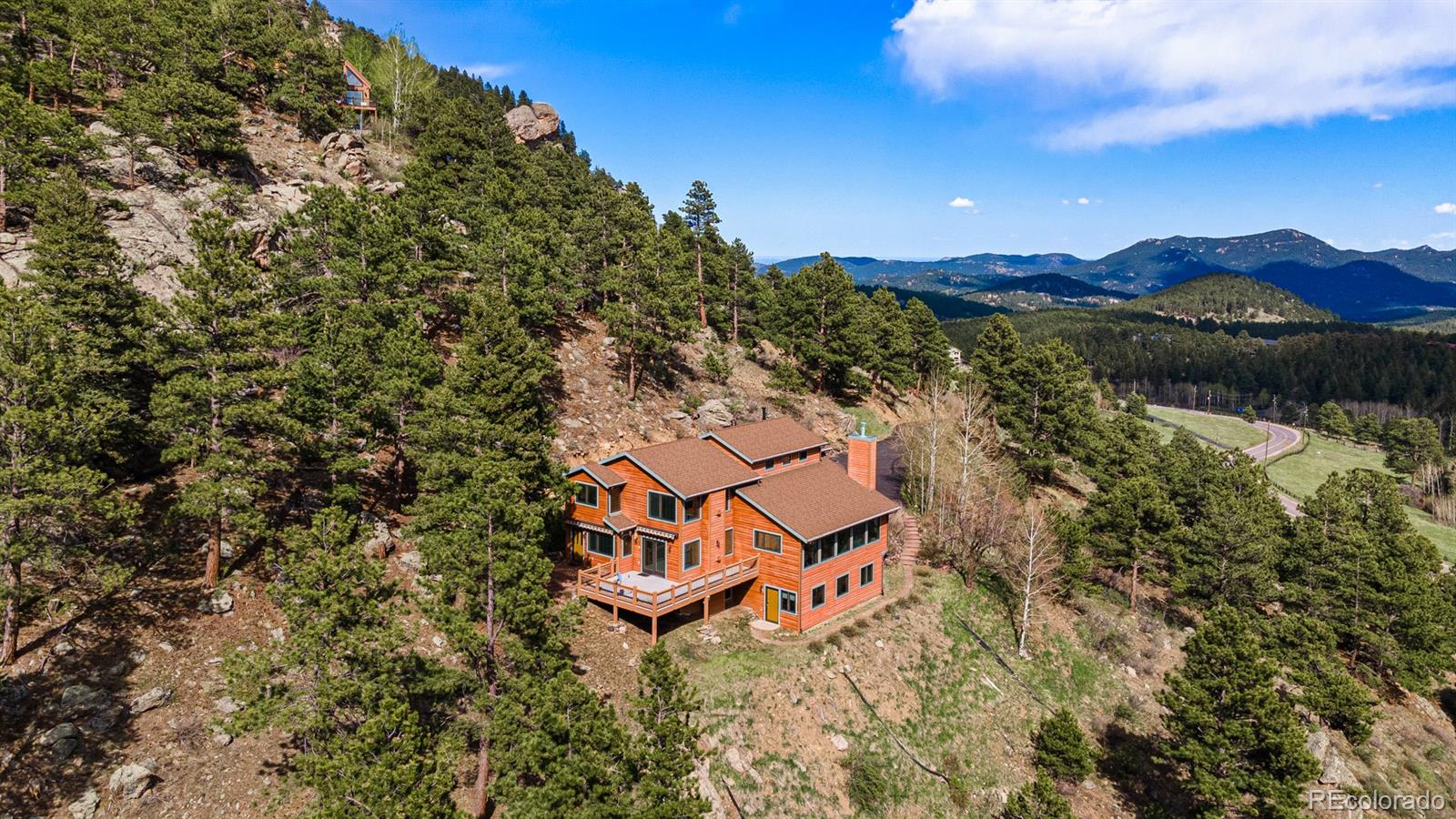 34187 Cactus Drive Evergreen, CO 80439 - Photo 3 of 39 a view of a houses with a lush green forest