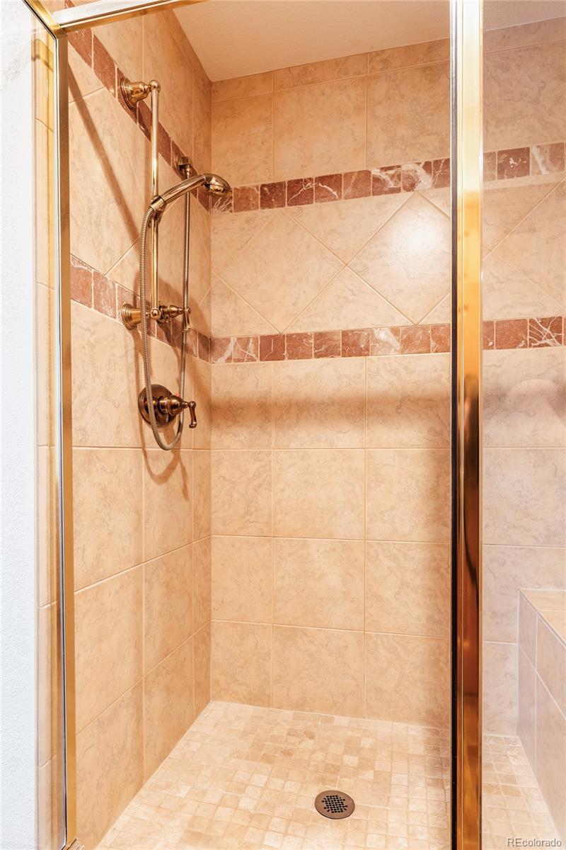 34187 Cactus Drive Evergreen, CO 80439 - Photo 32 of 39 a bathroom with a shower