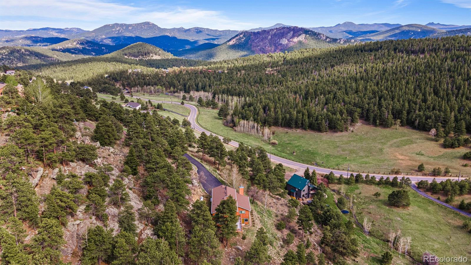 34187 Cactus Drive Evergreen, CO 80439 - Photo 38 of 39 a view of a town with mountains in the background