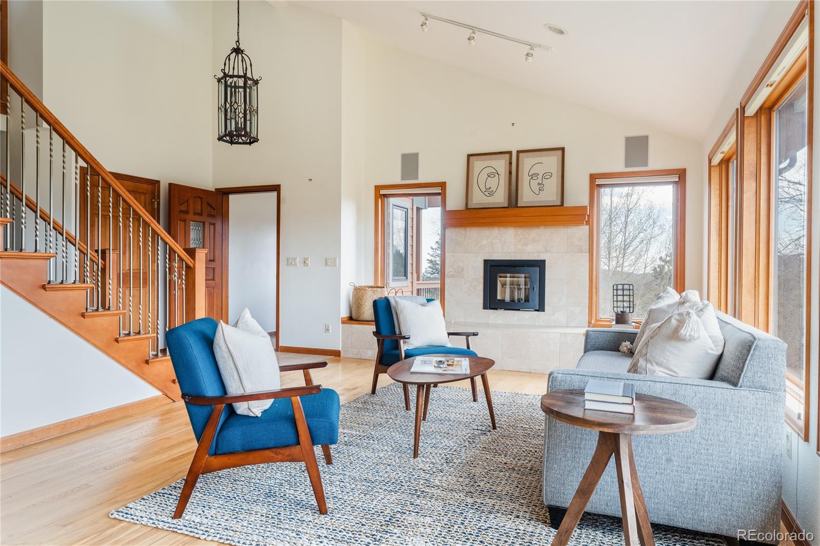 34187 Cactus Drive Evergreen, CO 80439 - Photo 9 of 39 a living room with furniture a fireplace and a window