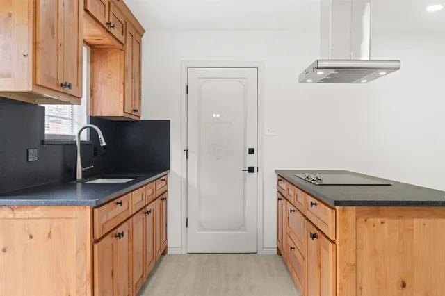 a kitchen with stainless steel appliances granite countertop a stove a sink and a refrigerator