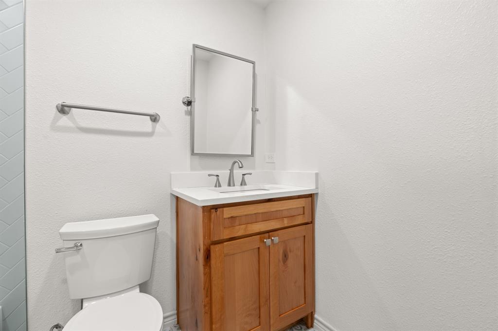 103 North Summit Street Red Oak, TX 75154 - Photo 19 of 30 a bathroom with a toilet sink and mirror