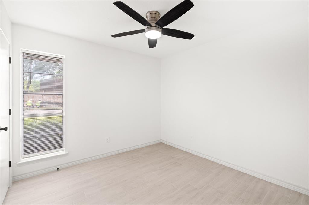 103 North Summit Street Red Oak, TX 75154 - Photo 20 of 30 an empty room with a window and a fan