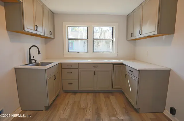 a kitchen with sink cabinets and window