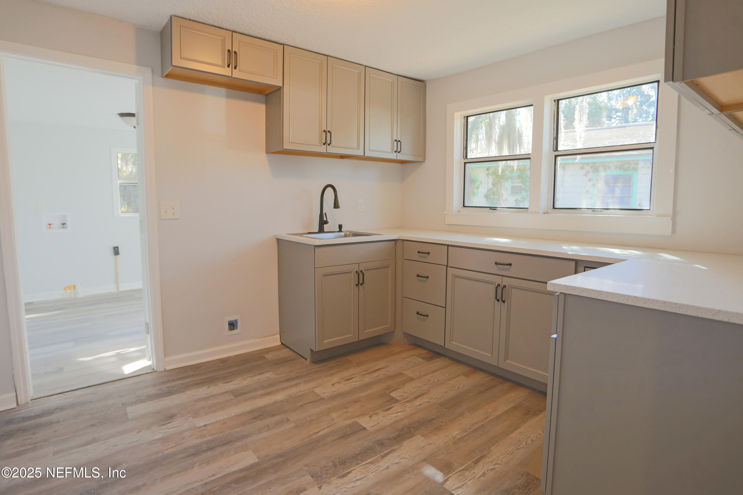 505 North 9th Street Palatka, FL 32177 - Photo 15 of 29 a kitchen with a sink cabinets appliances and a window