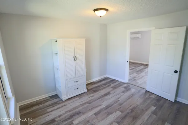 an empty room with wooden floor