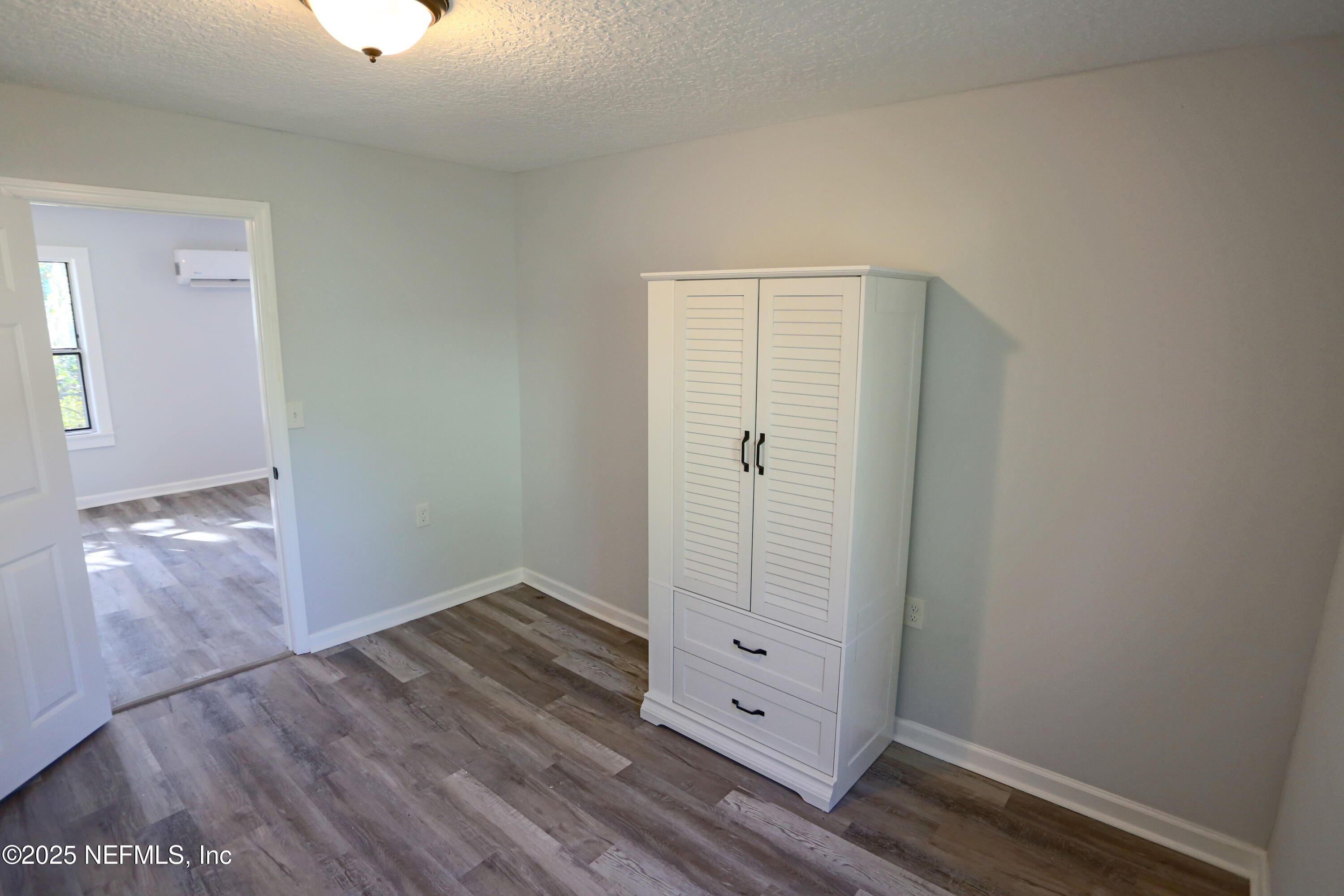 505 North 9th Street Palatka, FL 32177 - Photo 19 of 29 an empty room with wooden floor cabinet and windows