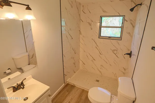 a bathroom with a sink toilet and shower