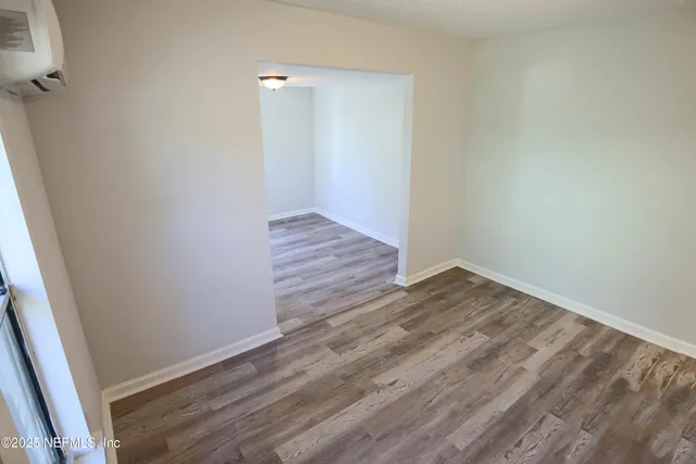 a view of a room with wooden floor