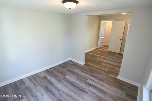 a view of wooden floor and windows in a room