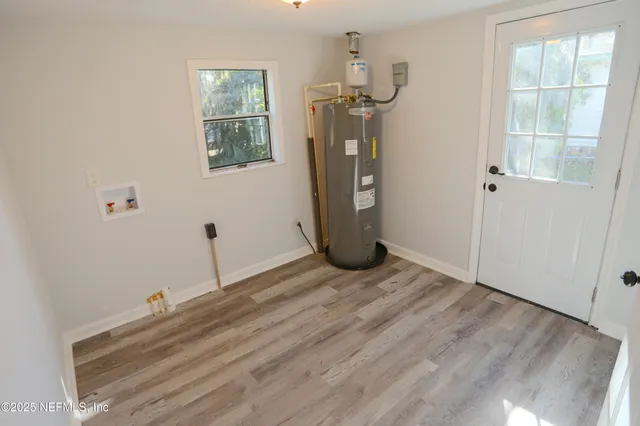 a view of a room with wooden floor and windows