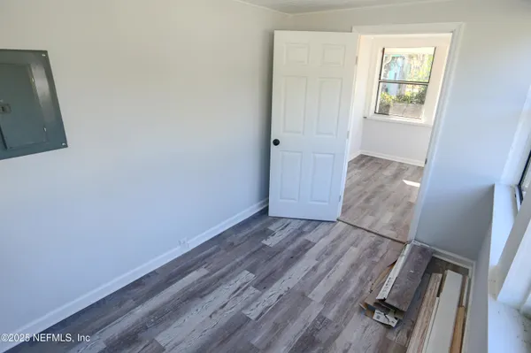 a view of room with window and hardwood floor