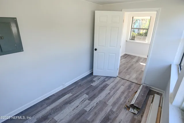 a view of room with window and hardwood floor