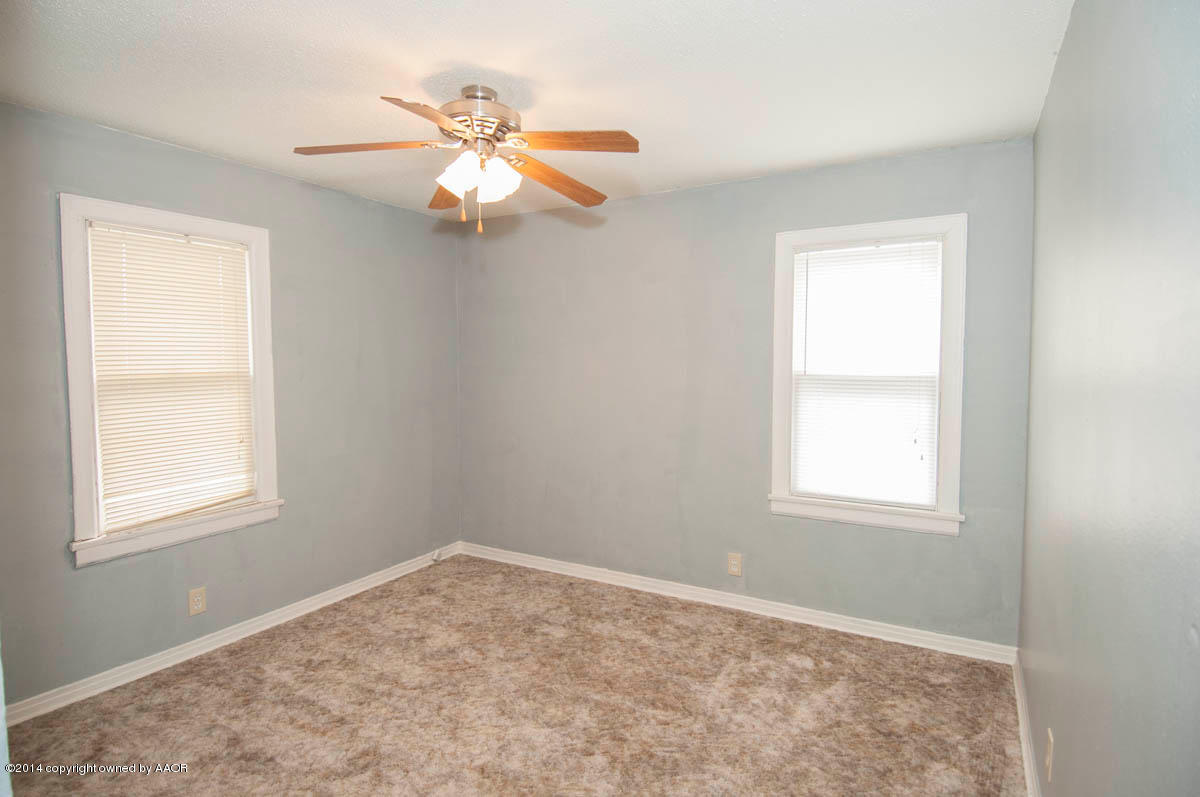 4125 South Ong Street Amarillo, TX 79110 - Photo 12 of 20 an empty room with windows and fan
