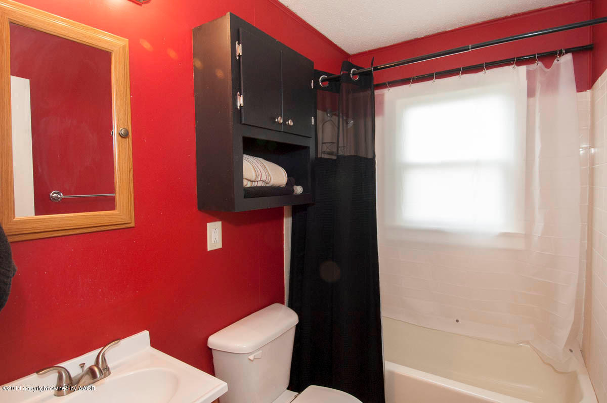 4125 South Ong Street Amarillo, TX 79110 - Photo 15 of 20 a bathroom with a toilet and a shower
