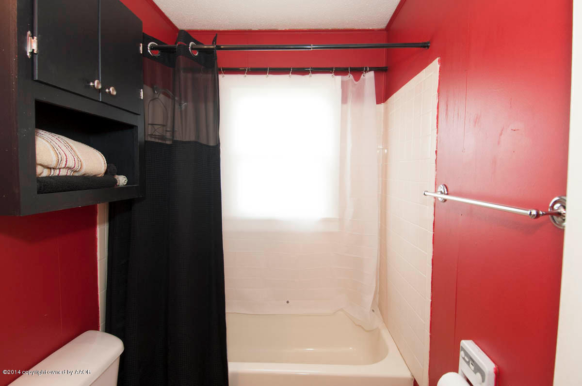 4125 South Ong Street Amarillo, TX 79110 - Photo 16 of 20 a bathroom with a shower and a toilet