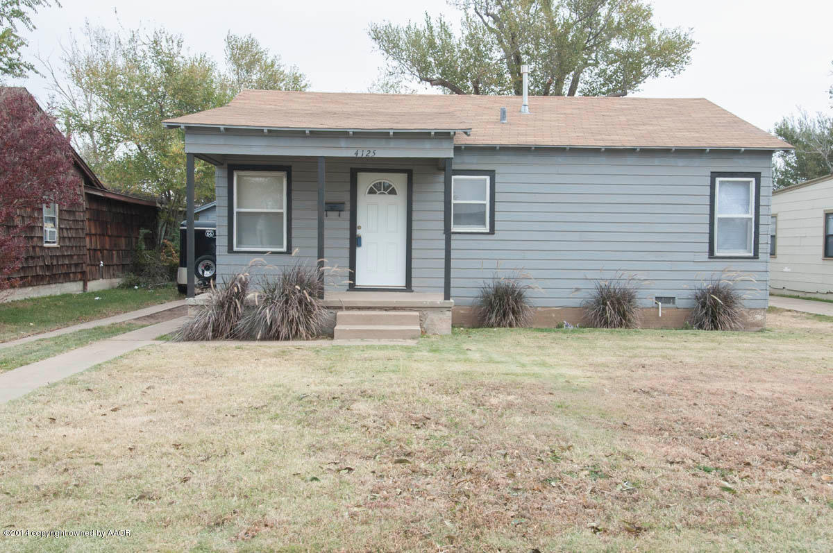 4125 South Ong Street Amarillo, TX 79110 - Photo 2 of 20 a front view of a house with a yard and garage