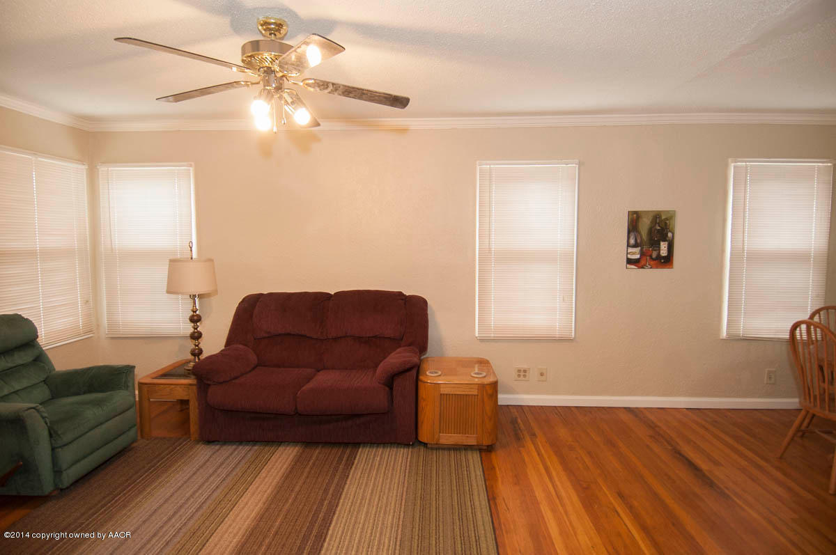 4125 South Ong Street Amarillo, TX 79110 - Photo 3 of 20 a living room with furniture and a wooden floor