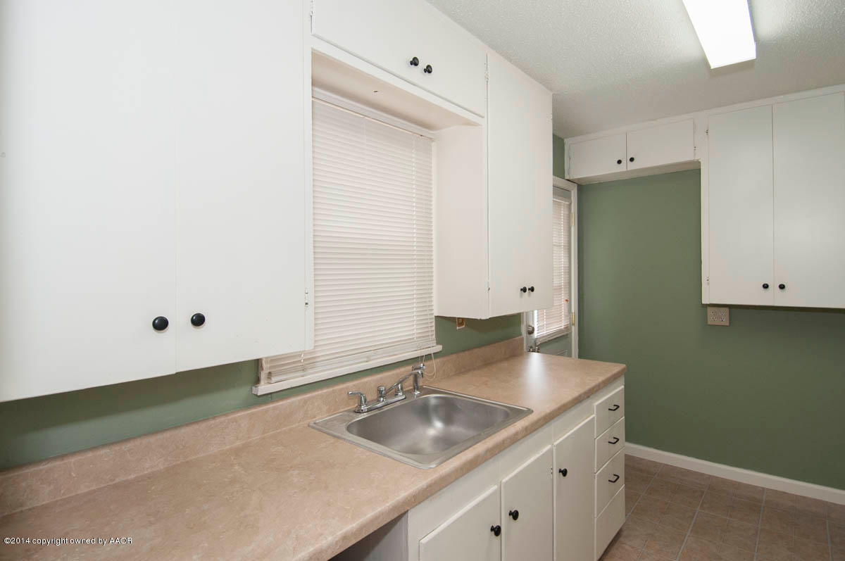 4125 South Ong Street Amarillo, TX 79110 - Photo 7 of 20 a bathroom with a granite countertop sink and a mirror