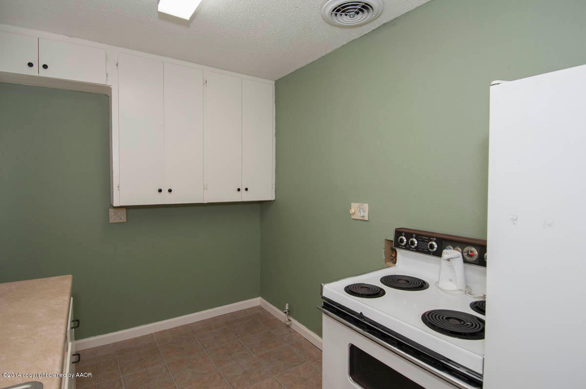 4125 South Ong Street Amarillo, TX 79110 - Photo 8 of 20 a kitchen with a stove and a sink