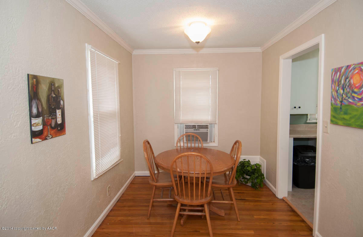 4125 South Ong Street Amarillo, TX 79110 - Photo 9 of 20 a view of a dining room with furniture and wooden floor