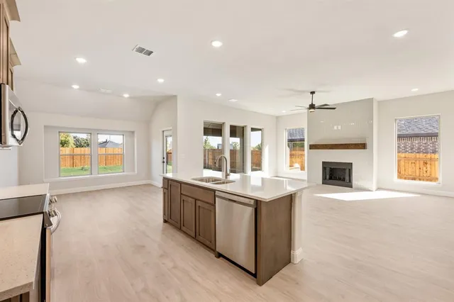 a large kitchen with a large counter top appliances and cabinets
