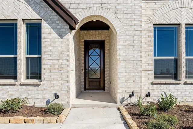 a front view of a house with glass windows